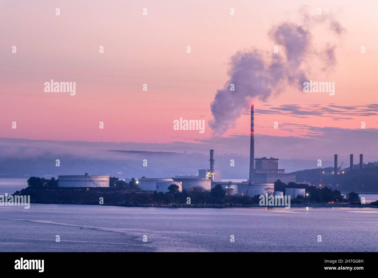 Aghada, Cork, Ireland. 23rd November, 2021. Early morning light begins to illuminate the oil refinery storage tanks and the ESB generating station in Aghada, Co. Cork, Ireland.  - Picture; David Creedon Stock Photo