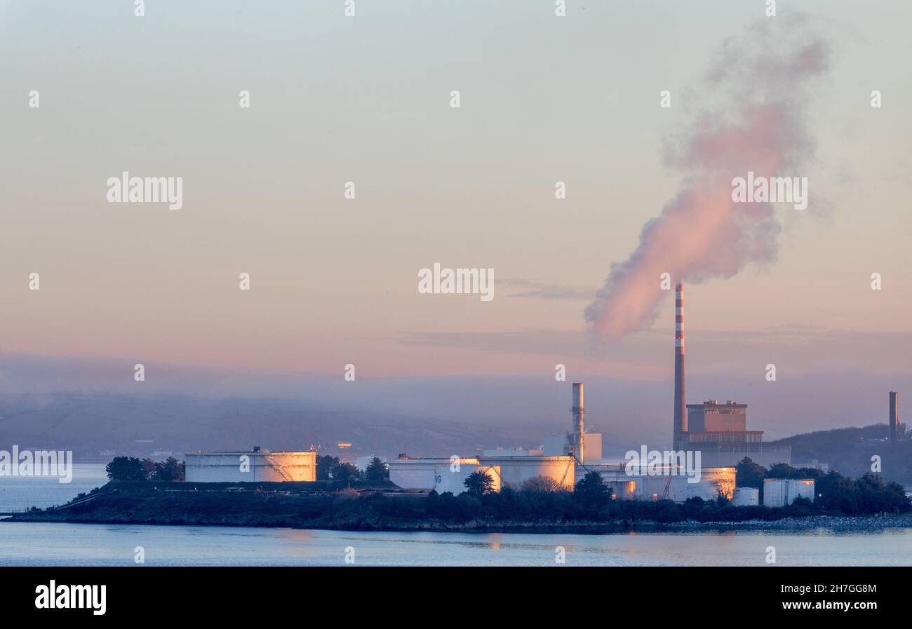 Aghada, Cork, Ireland. 23rd November, 2021. Early morning light begins to illuminate the oil refinery storage tanks and the ESB generating station in Aghada, Co. Cork, Ireland.  - Picture; David Creedon Stock Photo