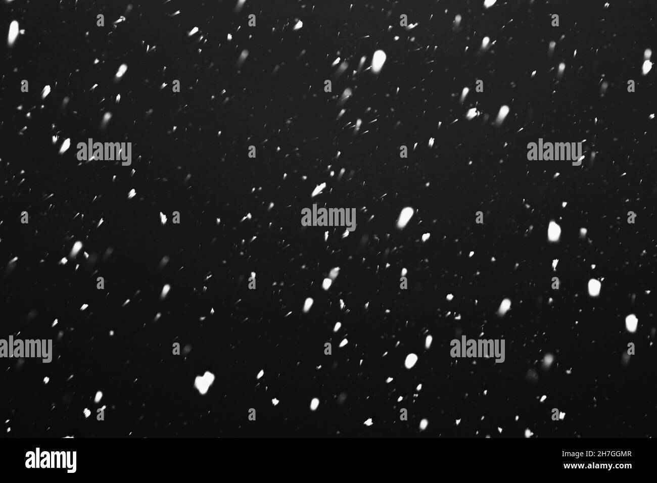 Heavy snowfall. Snow is falling against the sky. Snowflakes are flying. Winter, snowfall. Stock Photo