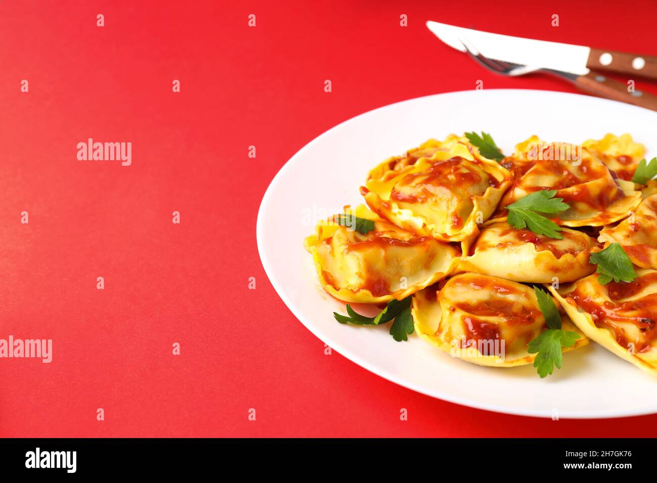 Delicious food concept with ravioli on red background Stock Photo