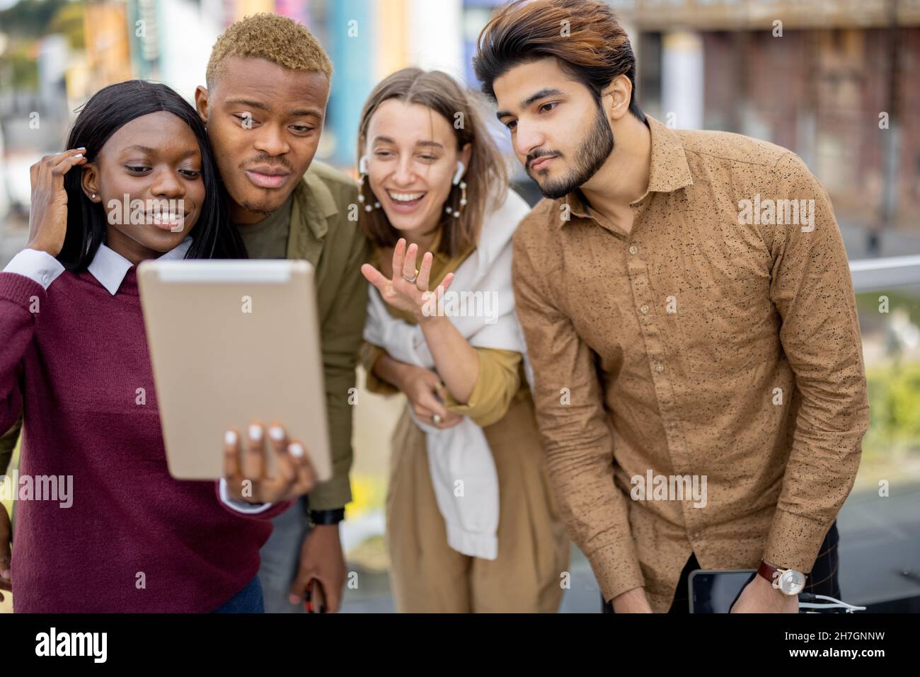 Multiracial students watch some on digital tablet Stock Photo