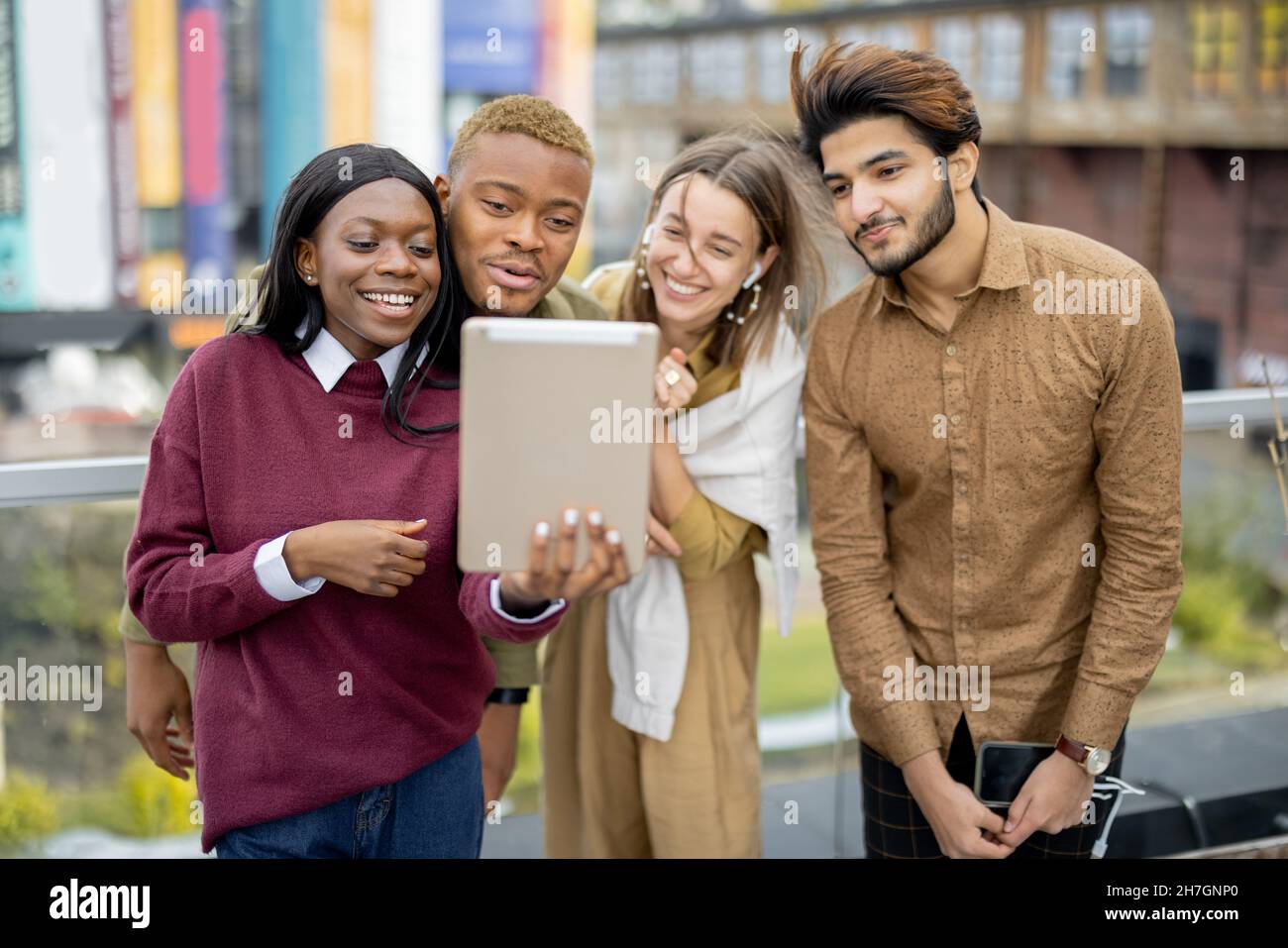 Multiracial students watch some on digital tablet Stock Photo