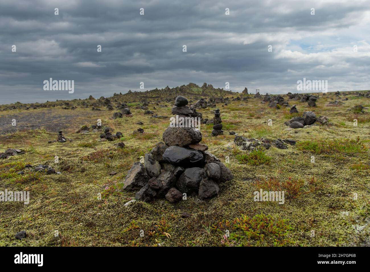 Low angle close up view of cairn or stone pile at the Laufskalavarda lava ridge in Iceland, built by travellers crossing the desert of Myrdalssandur Stock Photo