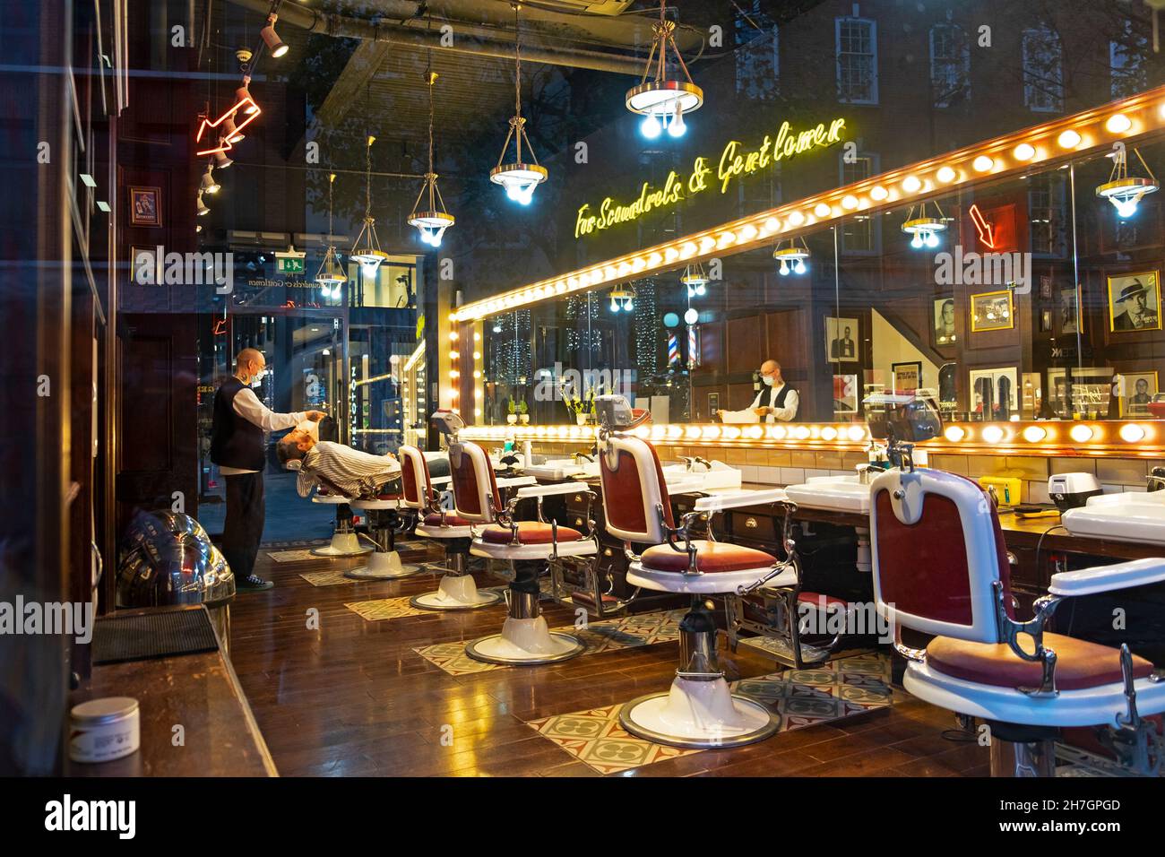 Interior view of barber shaving a customer in BarberBarber Barber shop