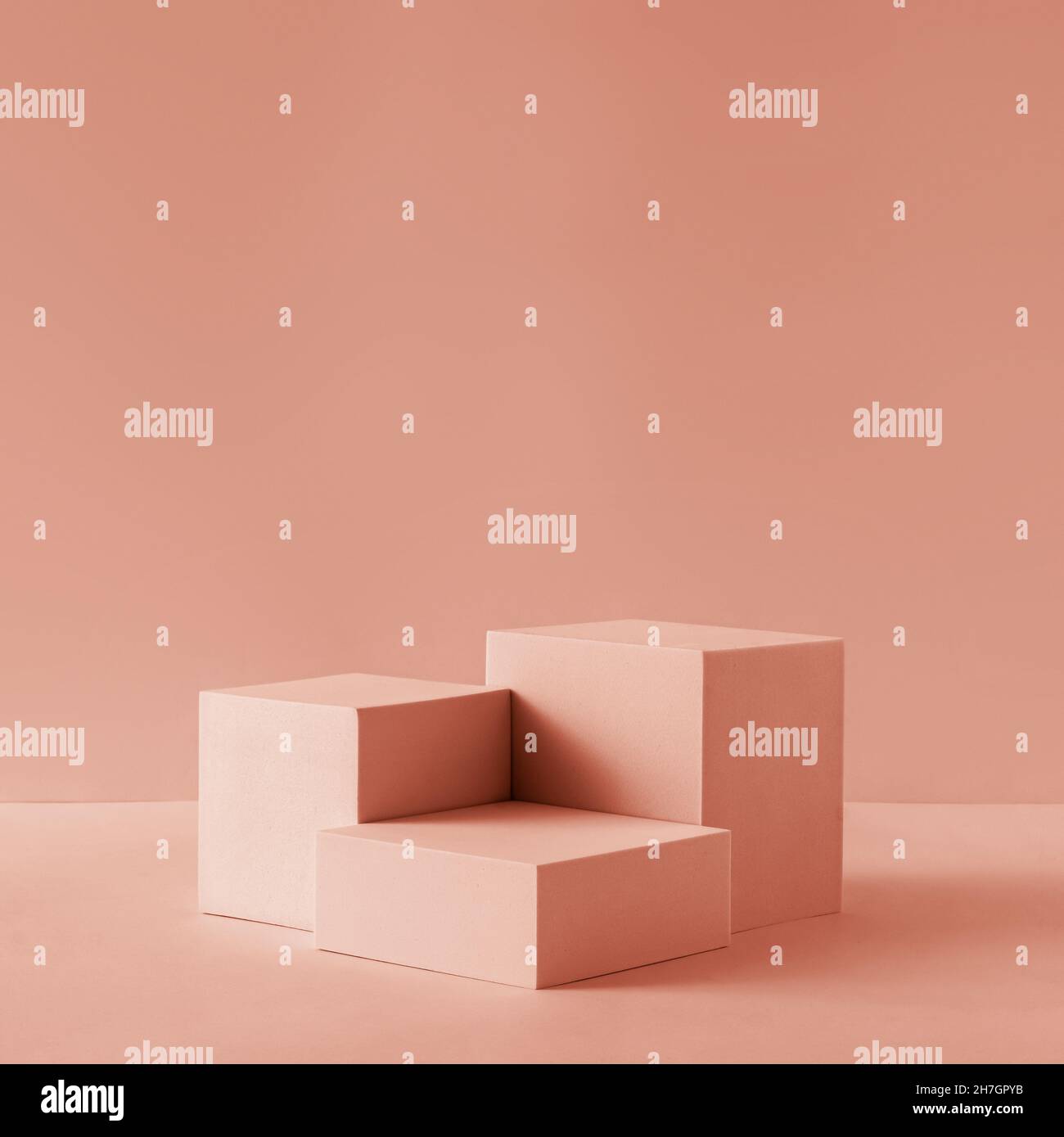 Awarding podium made of three 3d pastel square shapes of different sized against blank pink background for copy space Stock Photo