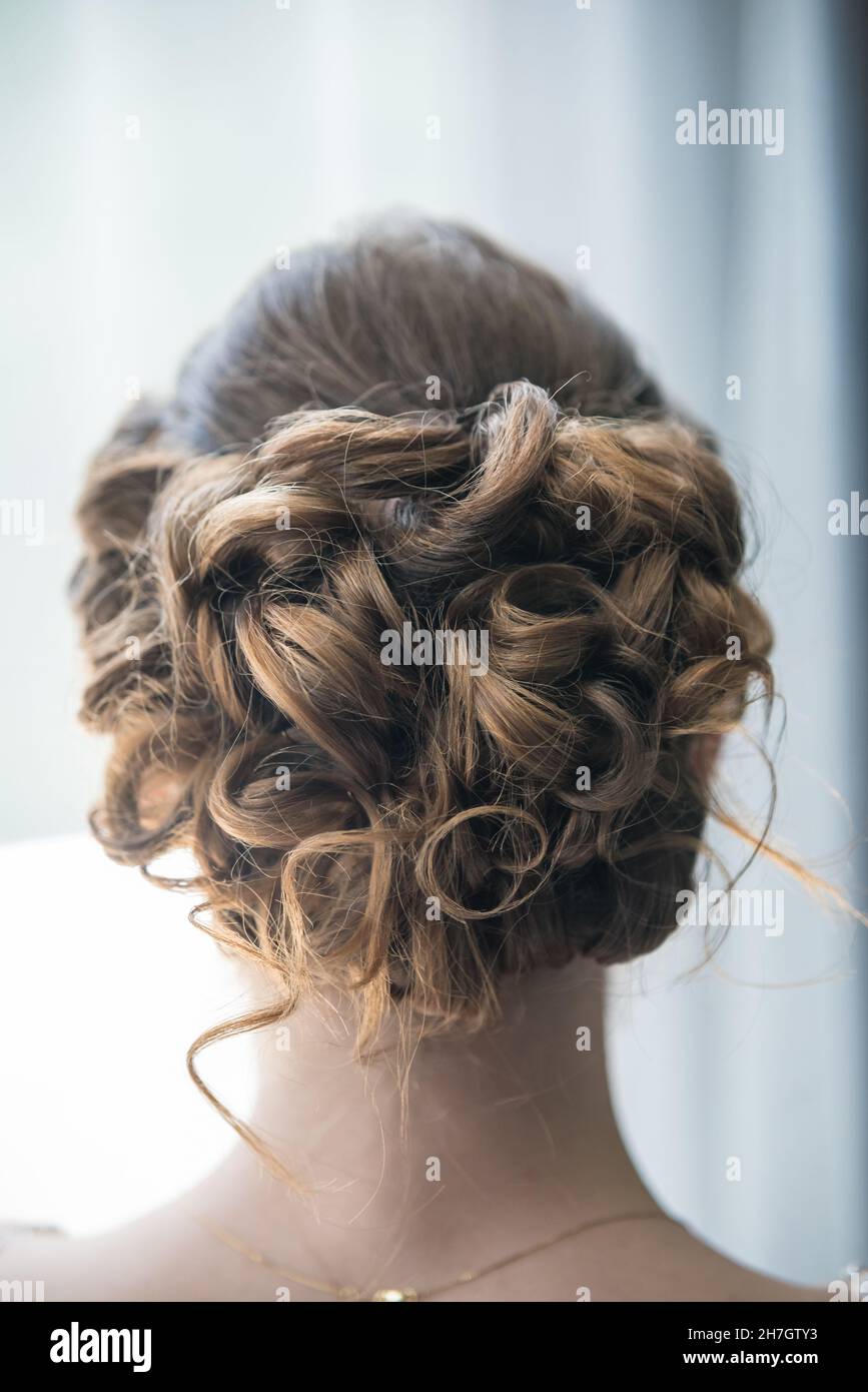Vertical shot of the back of the hair of the bride - elegant hairstyle with  curly hair Stock Photo - Alamy