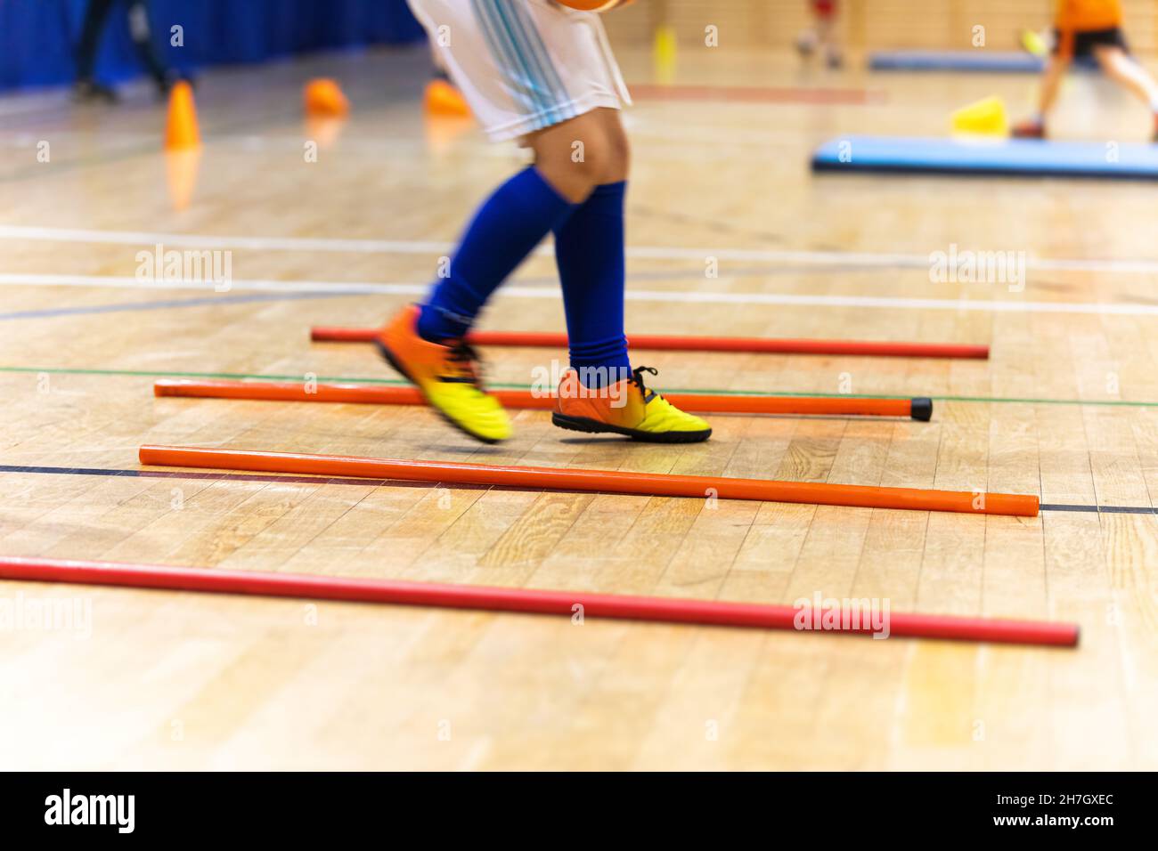 Happy Child Playing on Physical Education Indoor Class. Legs of Kid Boy Running on Training Drill in Sportswear. Practice Trail During Physical Educat Stock Photo