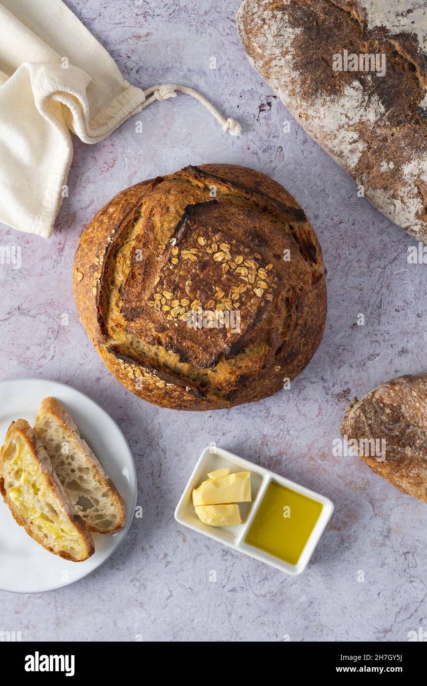 Artisanal sourdough bread, butter and olive oil Stock Photo