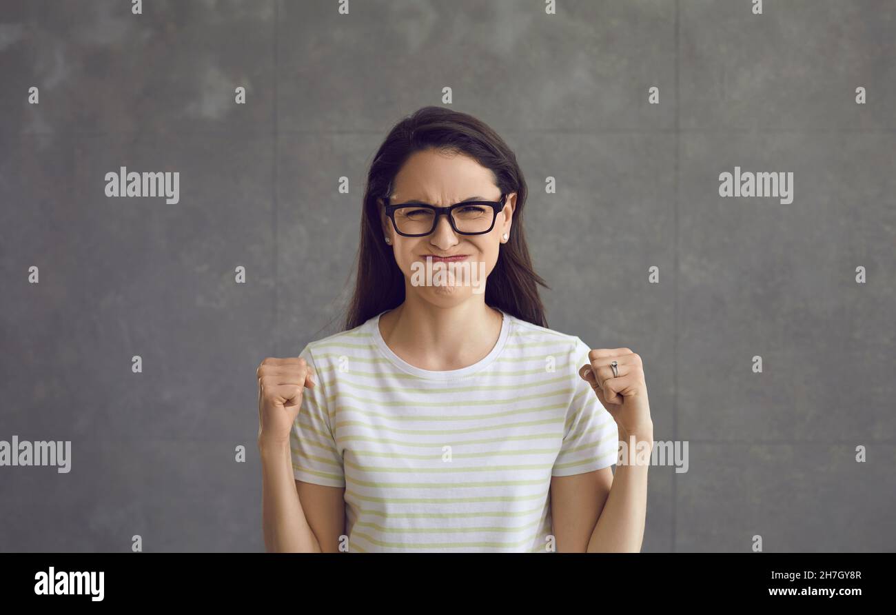 Woman puffed out her cheeks, rejoices, successful overcoming of difficulties. Stock Photo