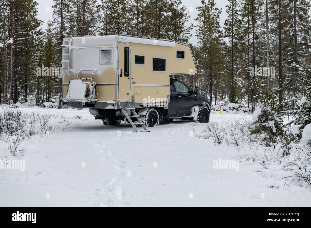 Van in deep snow in winter forest in Lapland, Arvidsjaur, Sweden Stock Photo