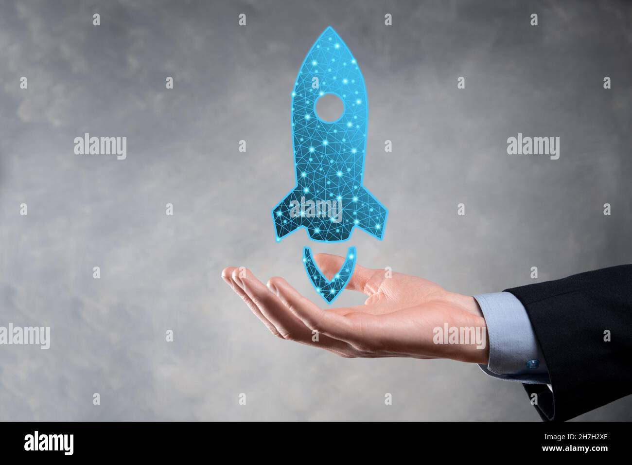 Startup business concept, Businessman holding in hand icon rocket is ...