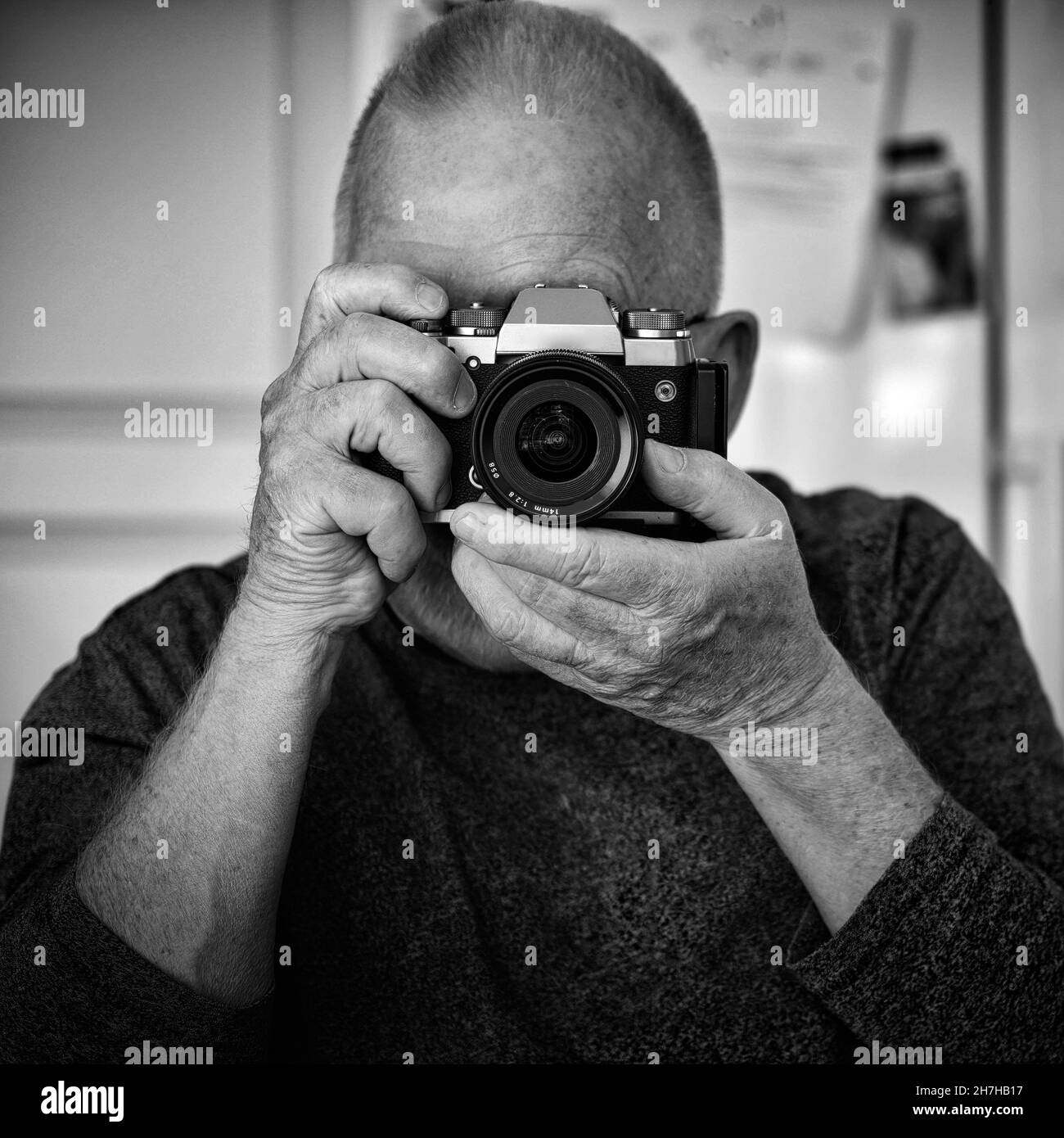 Elderly man taking photo with his digital camera Stock Photo