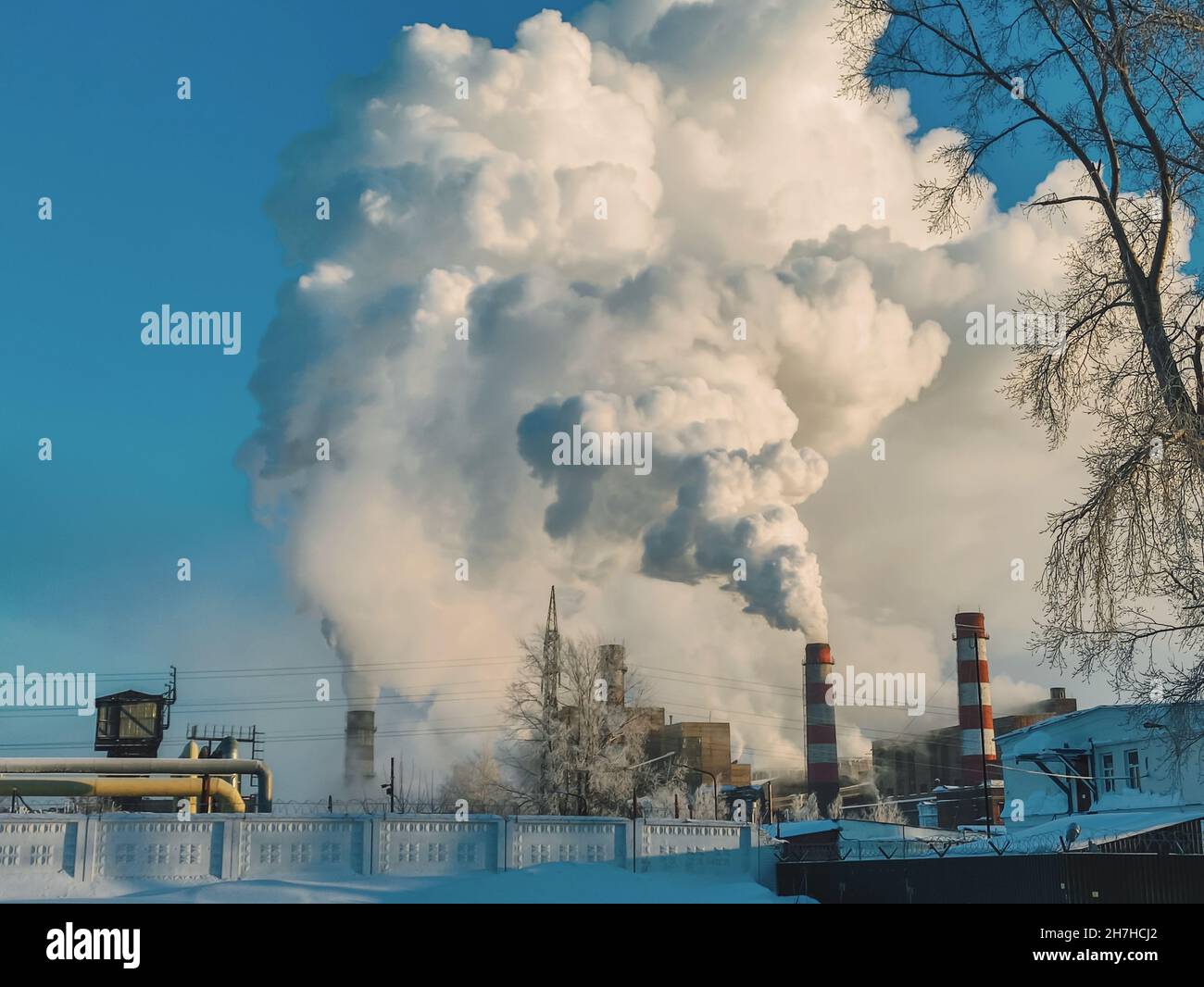 Chimney emissions from industrial lignite power plants. Huge clouds of smoke from chimneys, pipes of a thermal power plant, polluting the atmosphere Stock Photo