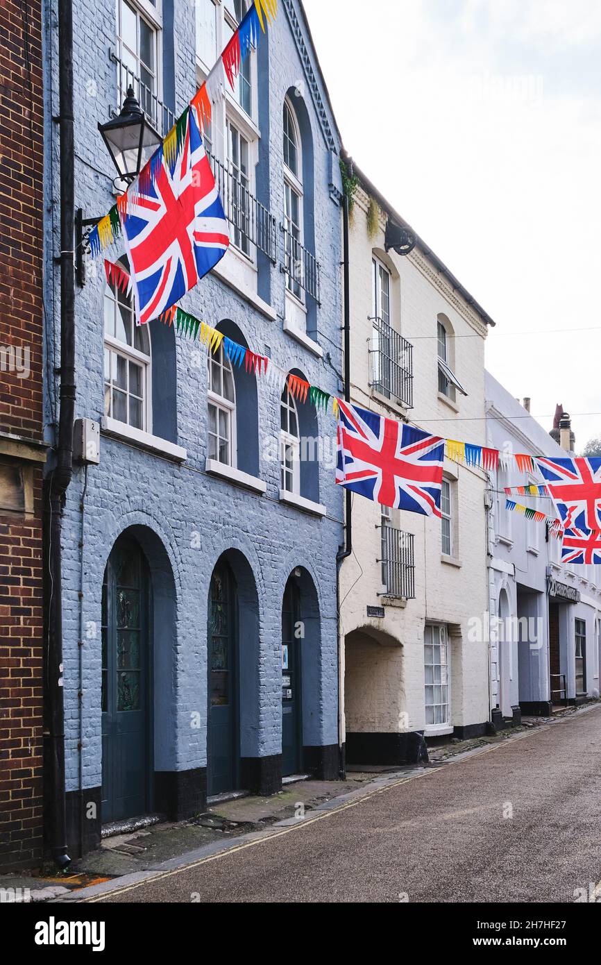 A street view of Courthouse Street buildings decorated wtih bunting for the Jack In the Green festival, in Old Town, Hastings, East Sussex, UK. Stock Photo