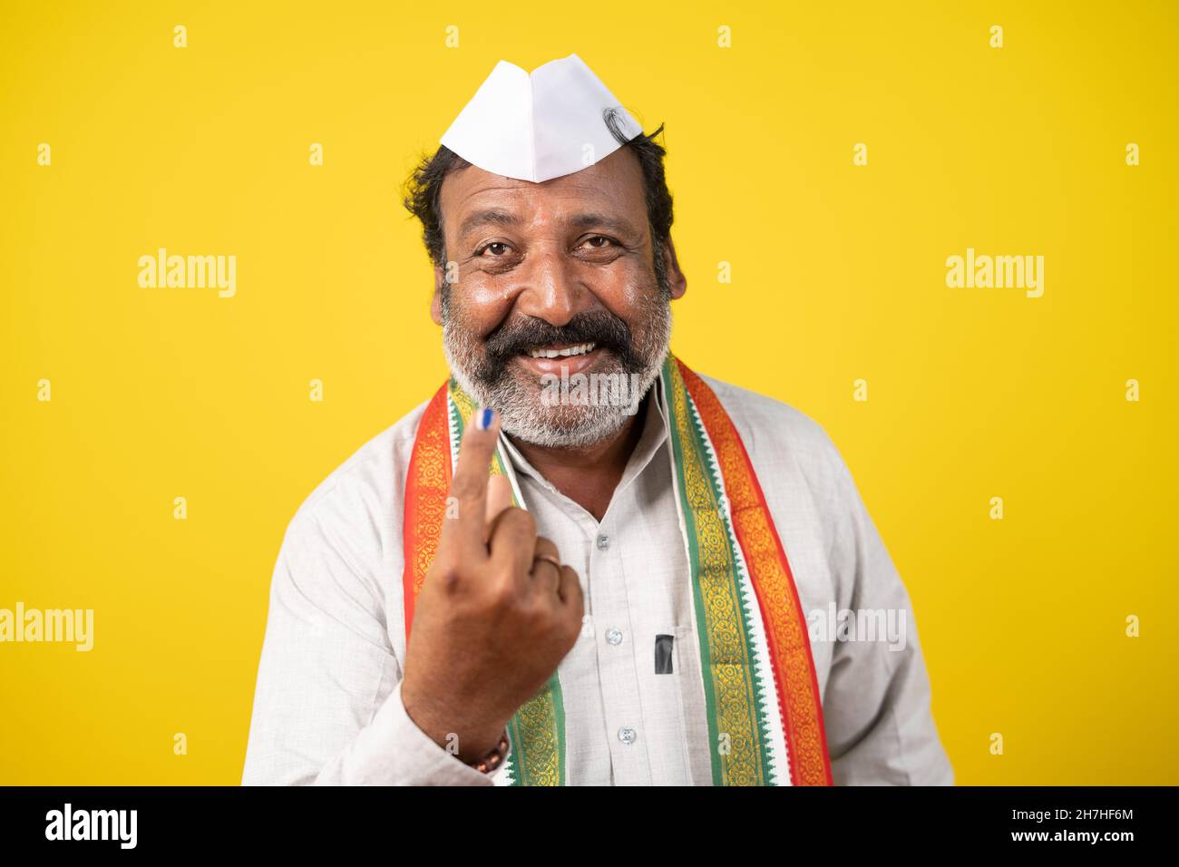 Happy smiling politician showing ink marked finger after voting in election polls - concept showing of Indian election and democractic system Stock Photo