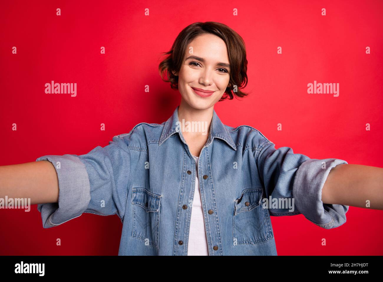 Photo of cool brunette young lady do selfie wear jeans shirt isolated on red  color background Stock Photo - Alamy