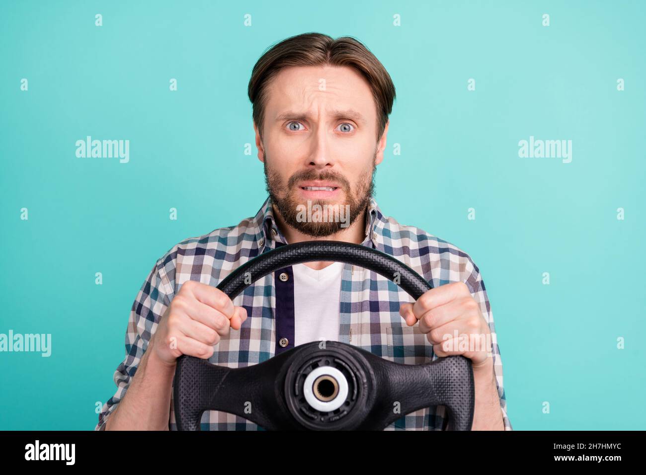 Photo of young man afraid scared worried ride car steering-wheel speed isolated over teal color background Stock Photo