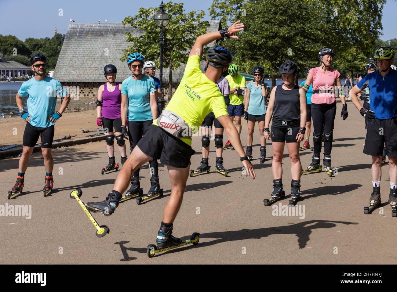 Group of people learning to roller-ski in Hyde Park, London, England UK Stock Photo