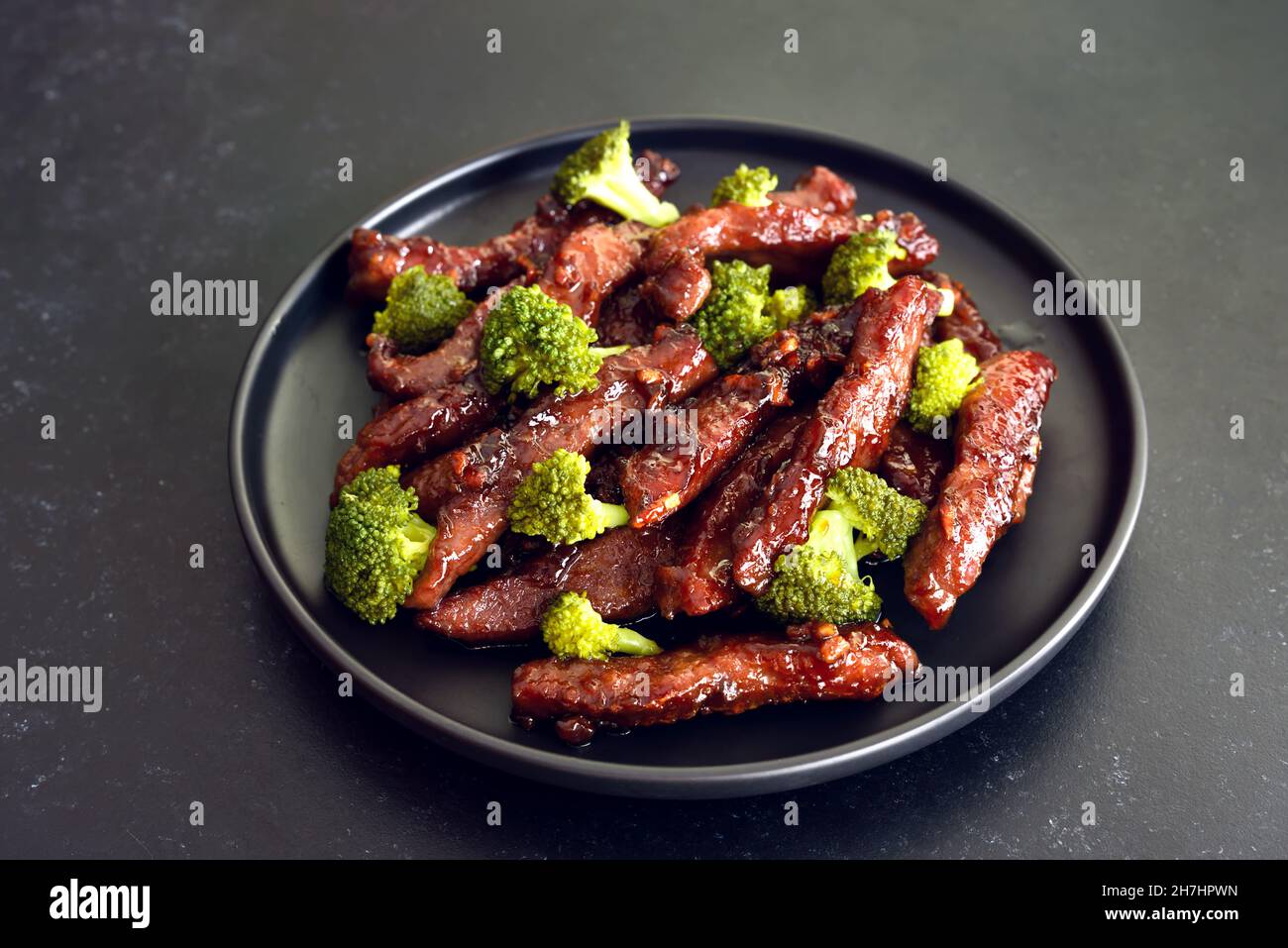 Beef stir-fry with broccoli on plate, close up view Stock Photo