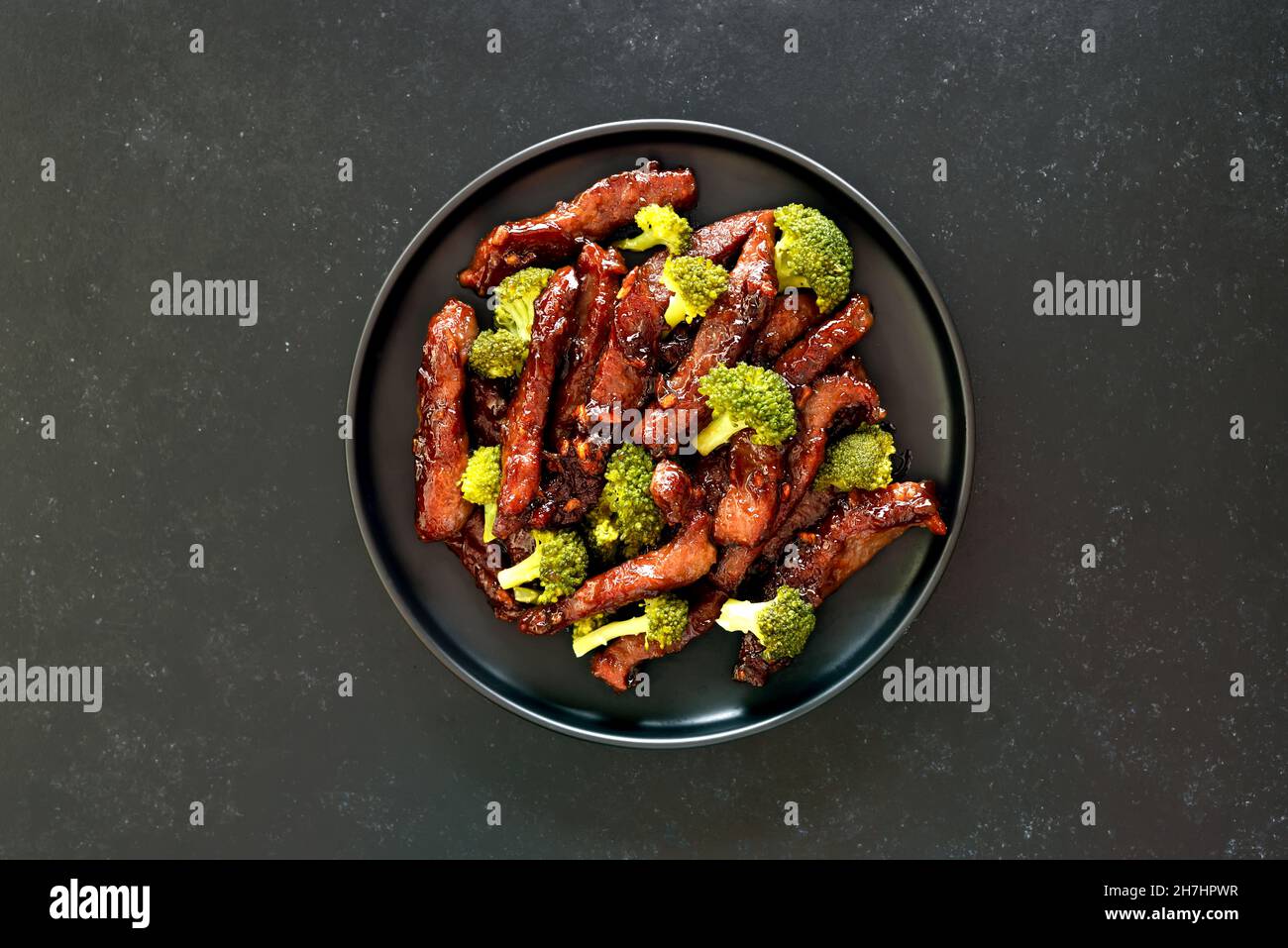 Beef and broccoli stir fry on dark background. Top view, flat lay Stock Photo