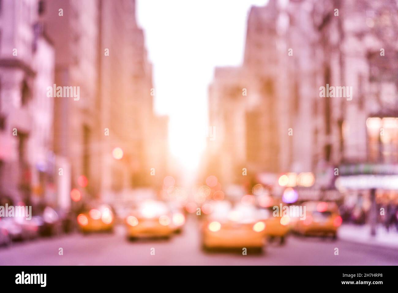 Rush hour with defocused yellow taxi cabs and traffic jam on 5th avenue in Manhattan downtown at sunset - Blurred bokeh postcard of New York City Stock Photo