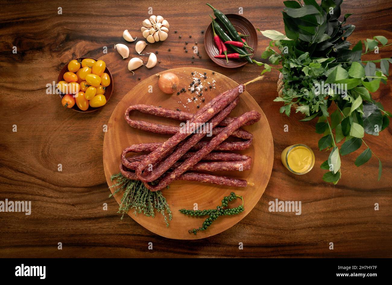 polish beef kabanos sausages on rustic wood table with natural ingredients arrangement Stock Photo
