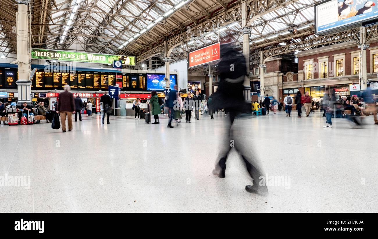 Victoria Train Station, London. Abstract long exposure blur of rush hour commuters and passengers at one of London's busiest transport hubs. Stock Photo