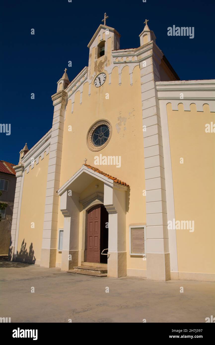 Holy Trinity Parish Church in the centre of Baska on Krk island, Primorje-Gorski Kotar County, western Croatia. Called Crkva sv Trojstvo in Croatian Stock Photo