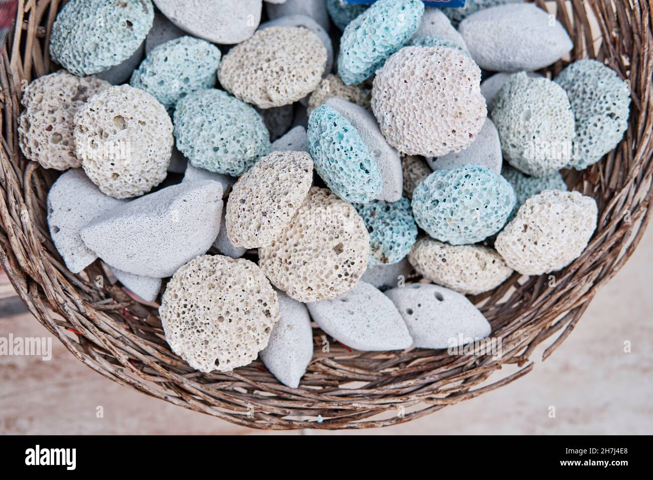 Colored pumice stones for feet in basket as souvenirs for tourists