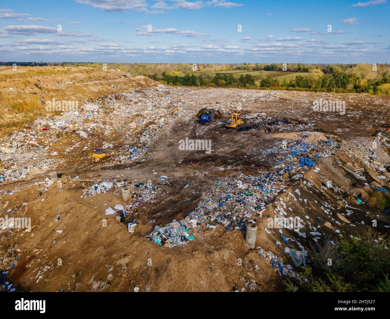 Garbage dump and working dump truck and bulldozer, aerial view Stock ...