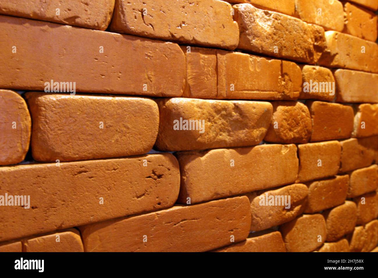Brick wall texture. Brick pattern made of different orange bricks, warm