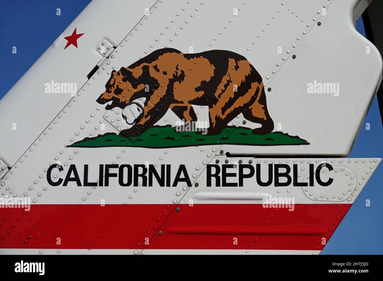 The California Republic (USA) Bear Flag logo is shown painted on the horizontal stabilizer of a helicopter during the day. Stock Photo