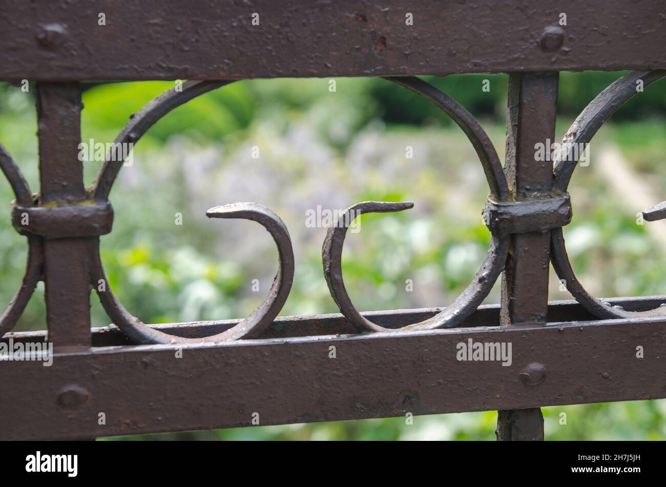Metal fence with blurred background Stock Photo - Alamy