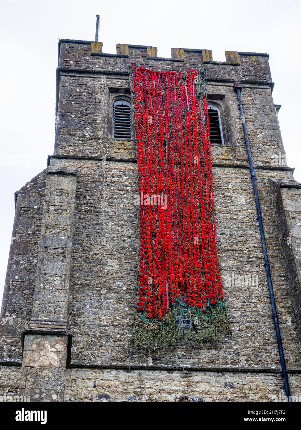 Knitted poppies adorning Biddenden church in Kent as part of the Remembrance Sunday and Armistice Day commemorations in the UK Stock Photo