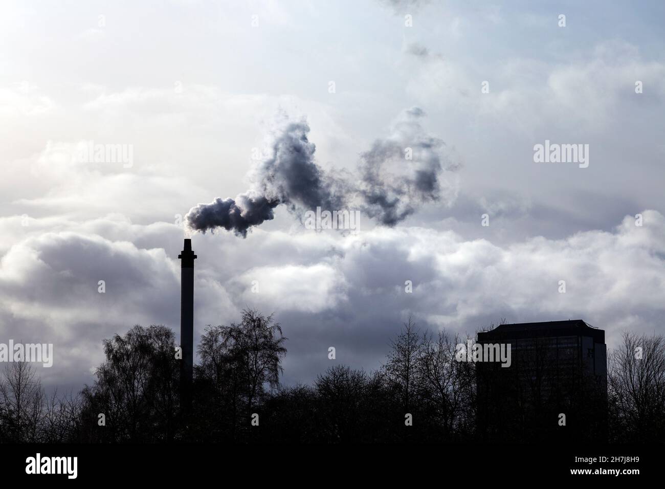 Thick smoke coming from an industrial chimney Stock Photo