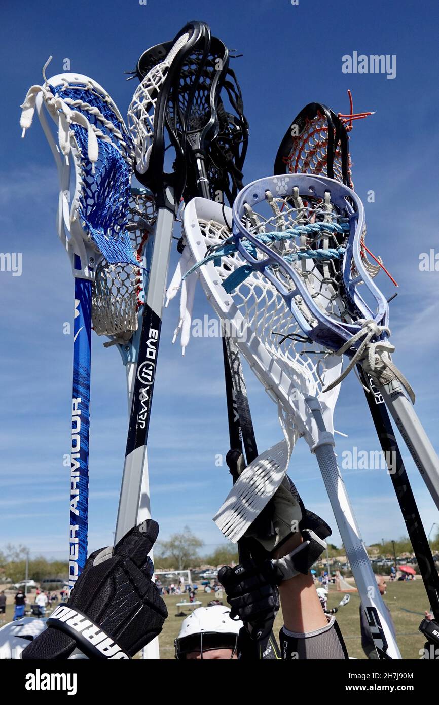 Lacrosse sticks are held in the air as a form of unity before breaking