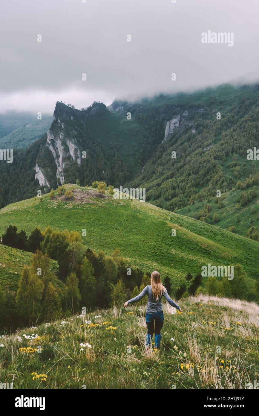 Woman traveling alone enjoying foggy mountains view  hiking adventure vacations outdoor healthy lifestyle active trip Stock Photo