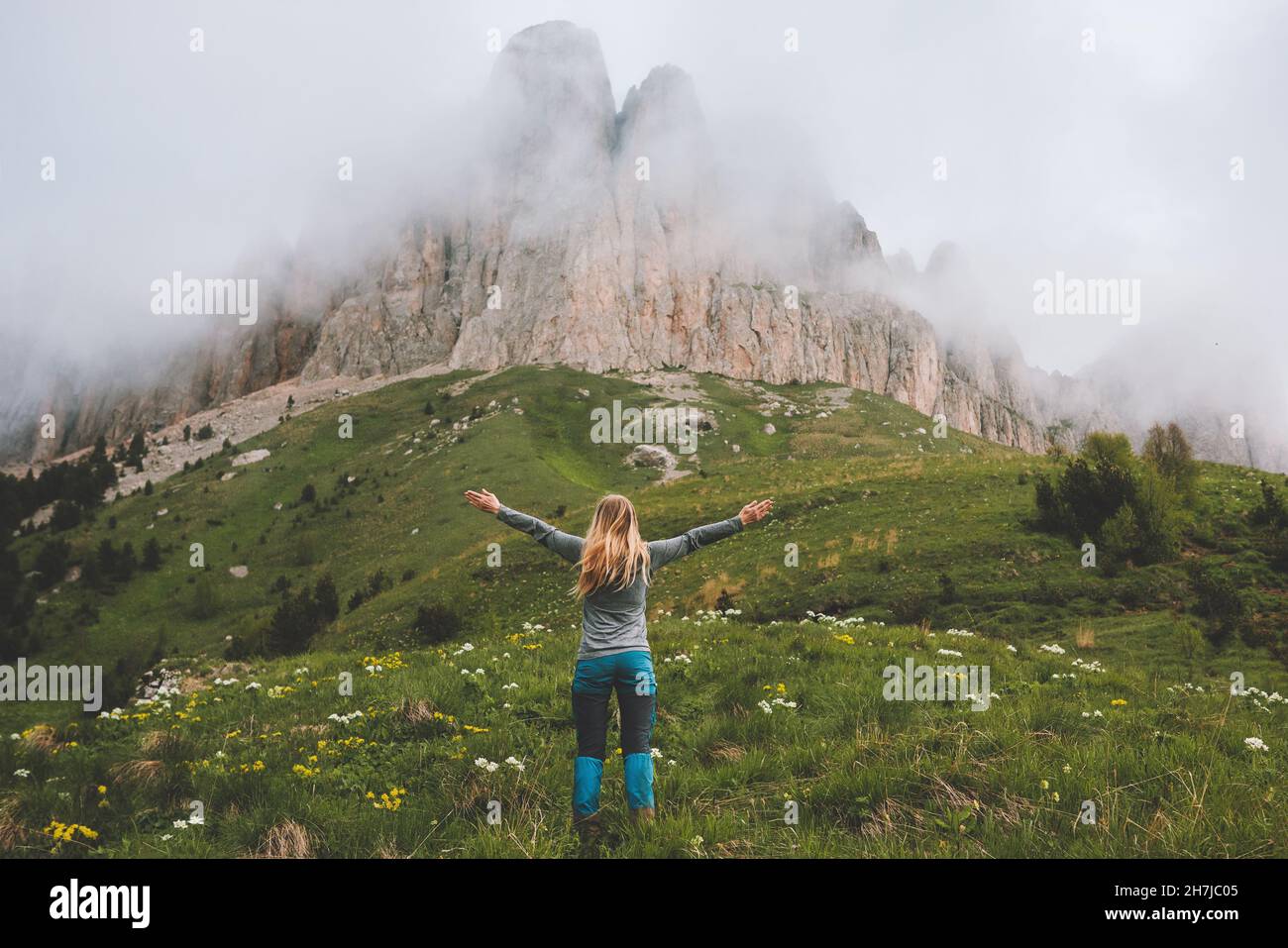 Freedom concept woman hiking in foggy mountains happy raised hands travel vacations outdoor healthy lifestyle activity eco tourism Stock Photo