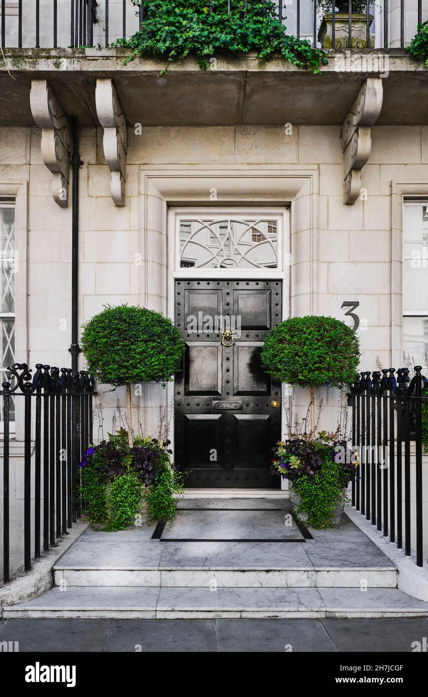 A doorway of a private residence with flower boxes in Kensington, London UK. Stock Photo