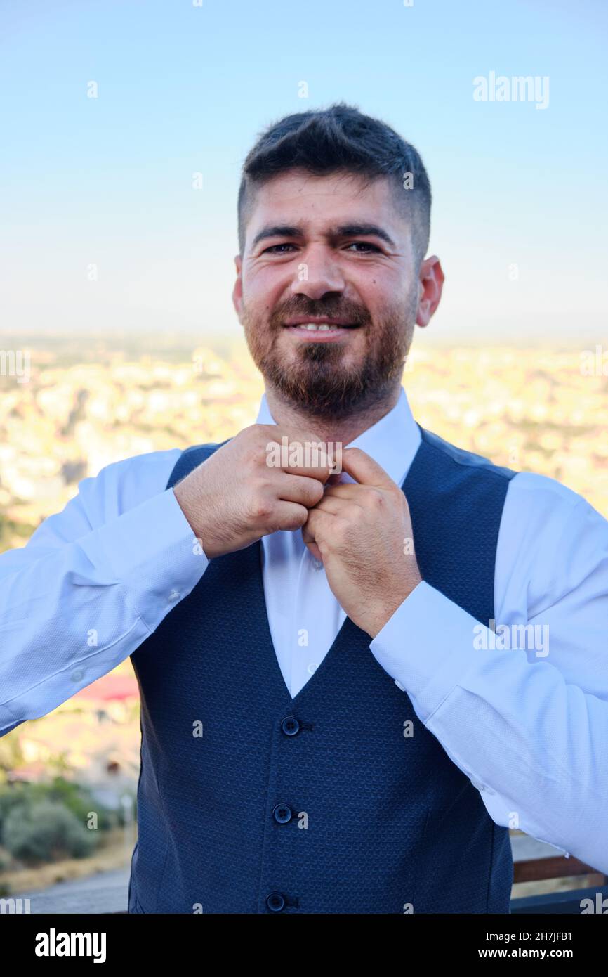 Man buttons his white shirt up Stock Photo - Alamy
