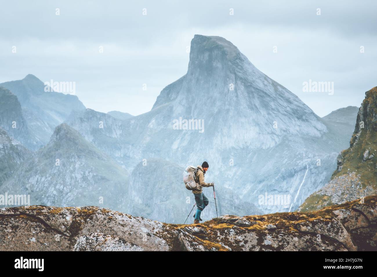 Man hiking in mountains traveling solo with backpack outdoor active vacations in Norway healthy lifestyle extreme sports Stock Photo