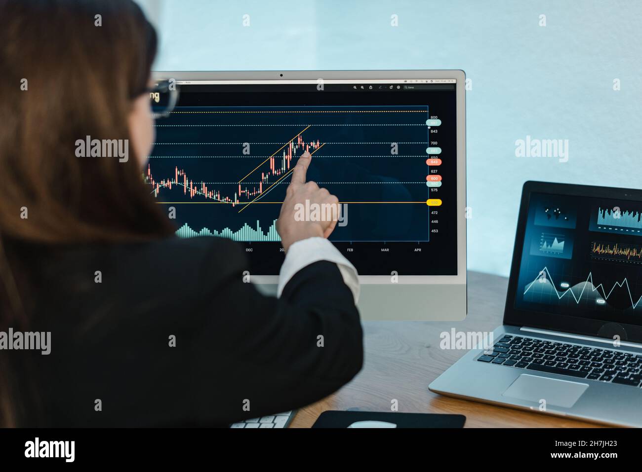 Crop woman analyzing graph on binary option Stock Photo