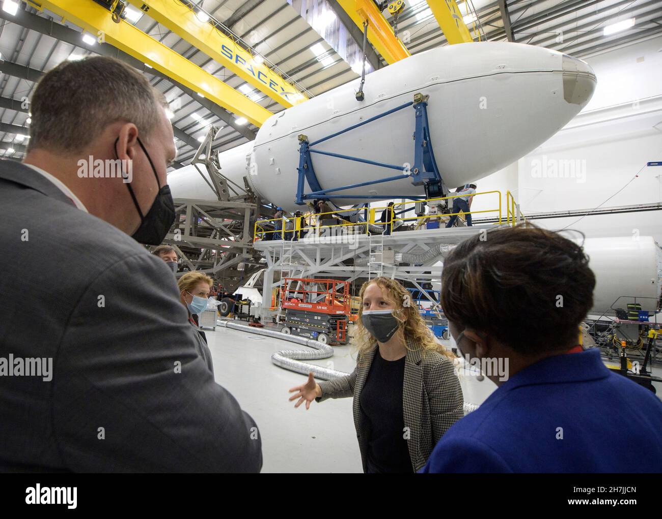 California.US, Nov. 23, 2021, NASA Associate Administrator for the Science Mission Directorate Thomas Zurbuchen, left, and other NASA leadership listen as Julianna Scheiman, director for civil satellite missions at SpaceX, center, gives a tour of the hanger where the Falcon 9 rocket and DART spacecraft are being readied for launch, Monday, Nov. 22, 2021, at Vandenberg Space Force Base in California. DART is the worlds first full-scale planetary defense test, demonstrating one method of asteroid deflection technology. The mission was built and is managed by Johns Hopkins APL for NASAs Planeta Stock Photo