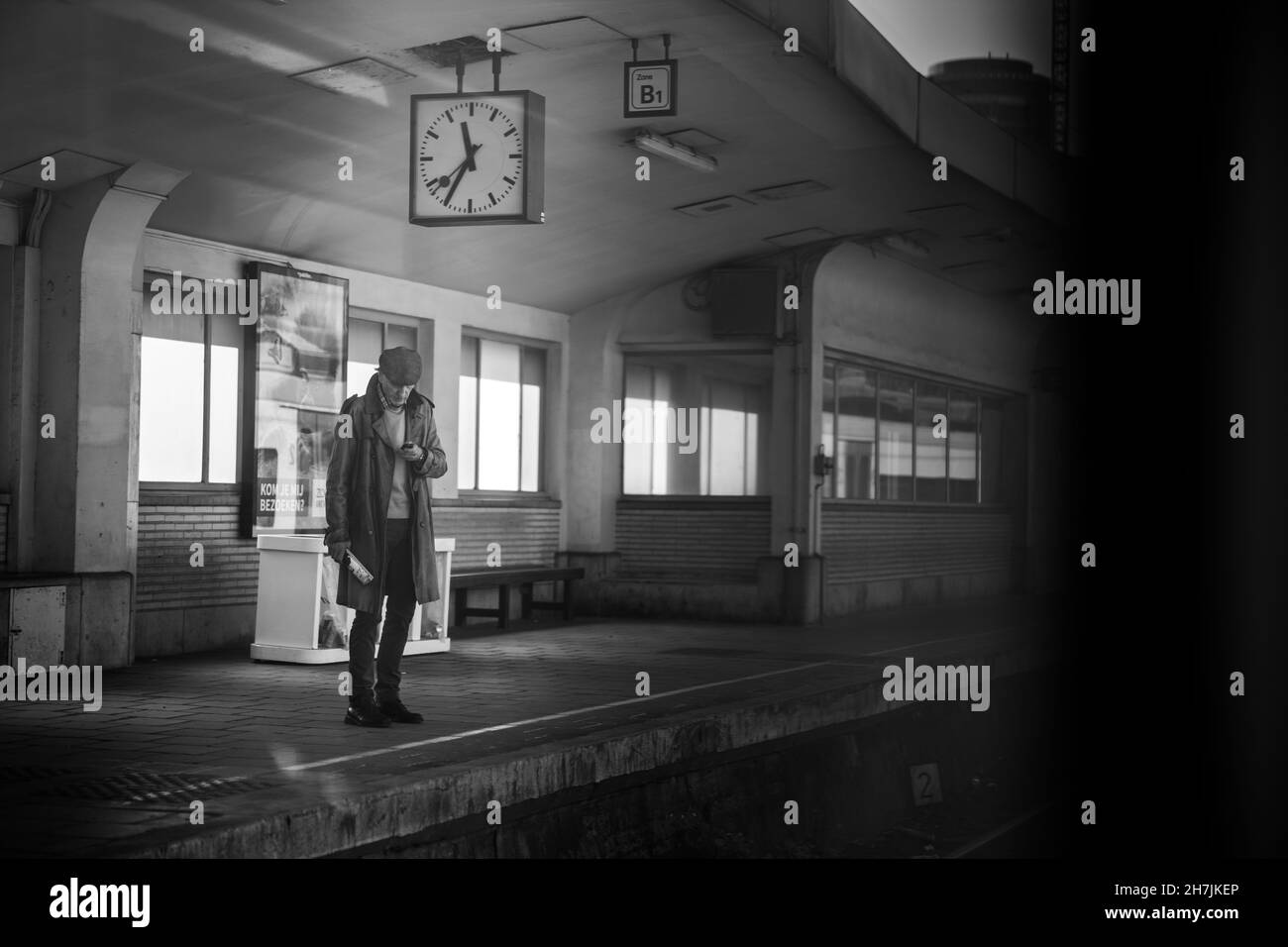 Elderly old man waiting for the train.An senior man waiting on a train station.Empty station time.Lonely feel landscape. High quality photo Stock Photo