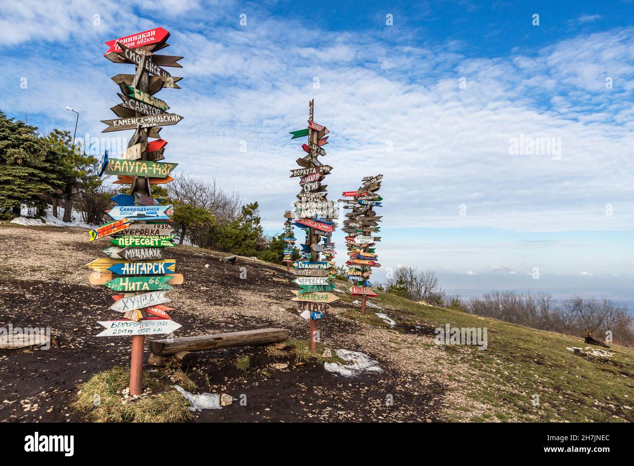 Caucasus, Pyatigorsk, Russia: Landscape on the mountain post with pointers cities and wooden bench on the peak Stock Photo