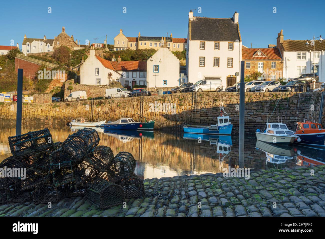 Fishing boats moored and lobster pots at Crail harbour, East Nuke coast, Fife, Scotland. Stock Photo