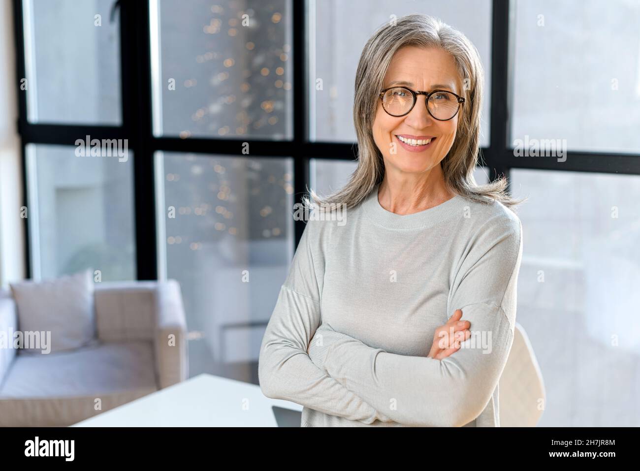 Portrait of proud and professional gray-haired mature business 