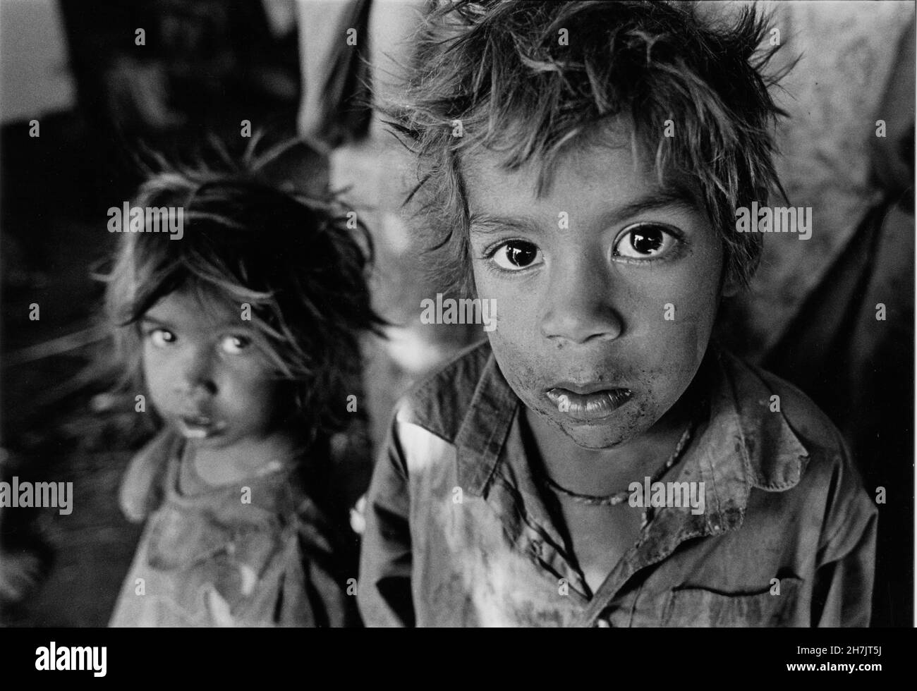 Young nomad children, locally known as Changhar or Jogia Wala, outside their tents at a slum, in Shialkot of Punjab Province, in Pakistan. They are me Stock Photo