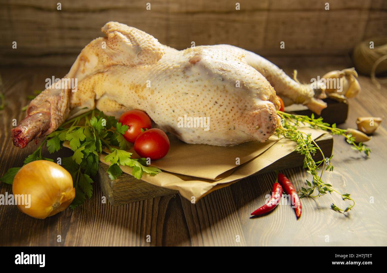 Chicken carcass with vegetables and herbs on a cutting board Stock Photo Alamy