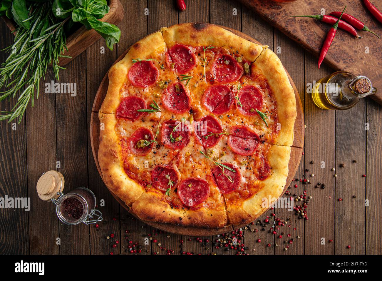 Pepperoni pizza with spicy salami and herbs Stock Photo Alamy
